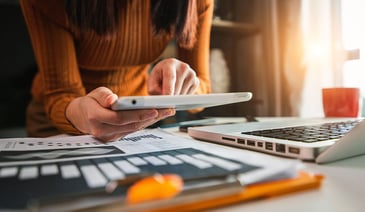 Businesswoman hand working digital marketing media in virtual screen with mobile phone and modern compute with VR icon diagram at office in morning light